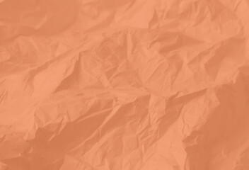 Crumpled paper Peach Fuzz color of the year 2024. Texture crumpled paper for your design. Copy space.