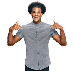 African american man with afro hair wearing casual clothes looking confident with smile on face,...