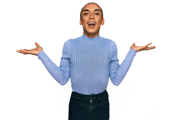 Hispanic transgender man wearing make up and long hair wearing casual clothes celebrating mad and crazy for success with arms raised and closed eyes screaming excited. winner concept