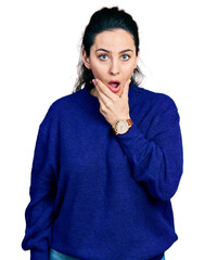 Young hispanic woman wearing casual clothes looking fascinated with disbelief, surprise and amazed expression with hands on chin