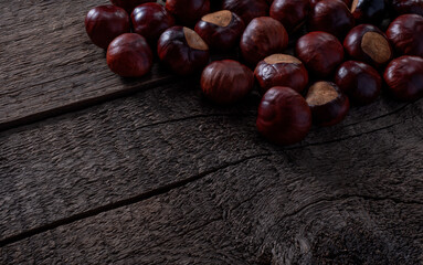 Chestnut on Wooden Rustic Surface. Template for Wallpaper or Background.