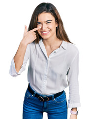 Young caucasian girl wearing casual white shirt pointing with hand finger to face and nose, smiling cheerful. beauty concept