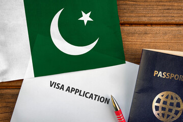 Visa application form, passport and flag of Pakistan
