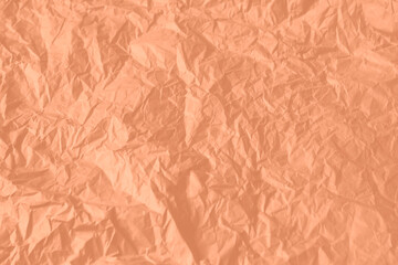 Crumpled paper Peach Fuzz color of the year 2024. Texture crumpled paper for your design. Copy space.