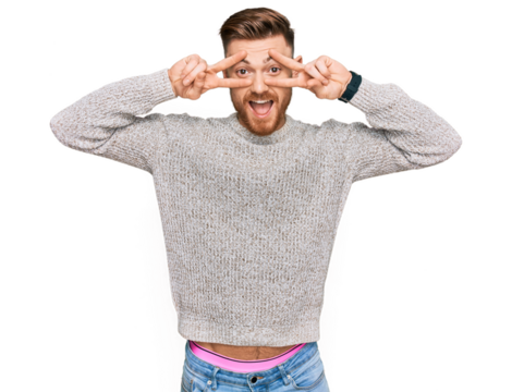 Young redhead man wearing casual winter sweater doing peace symbol with fingers over face, smiling cheerful showing victory - Powered by Adobe