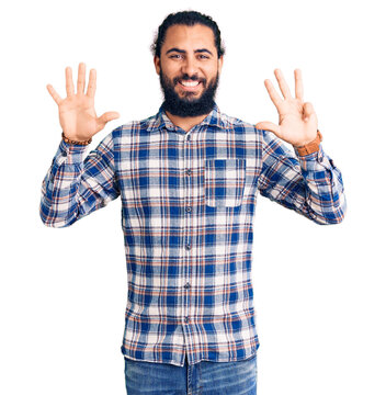 Young arab man wearing casual clothes showing and pointing up with fingers number nine while smiling confident and happy.