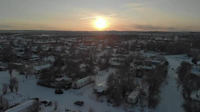 Sunset aerial view of Winter homes and trailers at Pine Ridge Indian Reservation in South Dakota aerial drone view of downtown