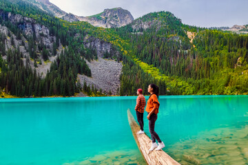 Joffre Lakes British Colombia Whistler Canada, a colorful lake of Joffre Lakes National Park in Canada. A couple of Asian women and caucasian men walking at Jofre Lake BC Canada