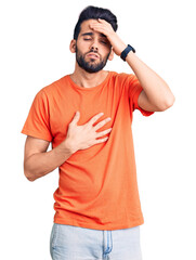 Young handsome man with beard wearing casual t-shirt touching forehead for illness and fever, flu and cold, virus sick