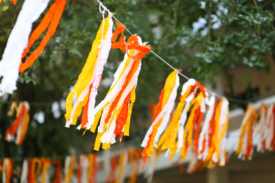 Colorful mobile paper handcraft decoration hanging on a tree in the garden.