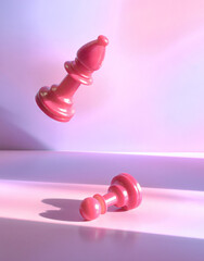 Pink Bishop Chess Piece Floating Over Lying Down Pawn Piece in Board Game Strategy Surrender...
