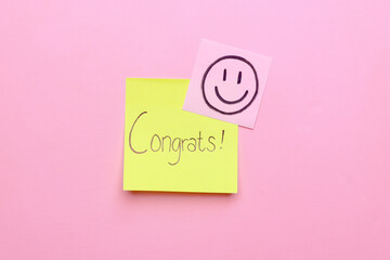Congratulation sticky notes on pink background