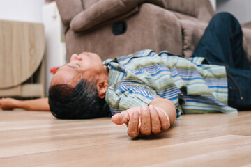 Unconscious old man lying on floor with epileptic seizures at home, senior injured at home.