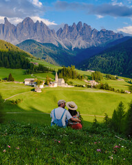 Couple at Santa Magdalena village South Tyrol Italy. Val di Funes valley in Italy, Santa Magdalena village Dolomites mountains, men and women on vacation Italian Alps © Fokke Baarssen