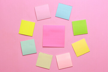 Blank multicolor sticky notes on pink background.
