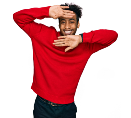 Young african american man with beard wearing casual winter sweater smiling cheerful playing peek a boo with hands showing face. surprised and exited