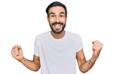 Young hispanic man wearing casual white t shirt celebrating surprised and amazed for success with arms raised and open eyes. winner concept.