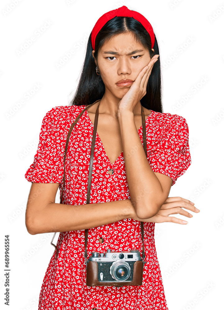 Poster beautiful young asian woman wearing dress and vintage camera thinking looking tired and bored with d