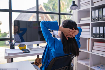 Fototapeta premium Young businesswoman relaxing at workplace in office