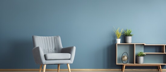 Photo of a blue chair in a spacious living room with grey walls, wooden floor, shelf, and table.