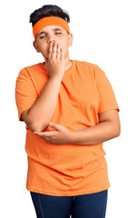 Little boy kid wearing sportswear bored yawning tired covering mouth with hand. restless and sleepiness.