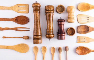 Various kitchen utensils made of natural materials on a light background. Flat laying. Top view. Eco items.