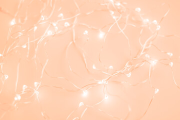 Luminous garland trending color of year 2024 Peach Fuzz.