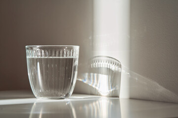 A glass of clean drinking water in the morning sun.