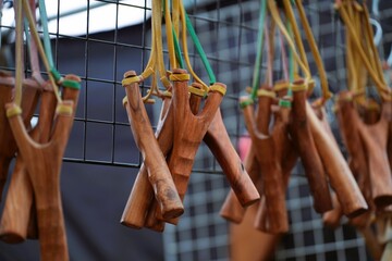 A small slingshot made from hanging sticks together.