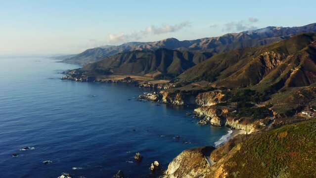 4k aerial drone footage of a Mountain Along Pacific Coast in Monterey. Big Sur national park, California road to San Francisco. Spectacular view on the blue ocean on the sunset