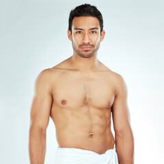 Body, chest and portrait of asian man in a towel in studio for cleaning, hygiene and care on white...