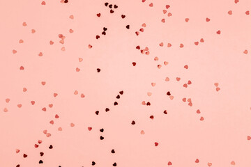 Pink background with glitter hearts for valentine's day.