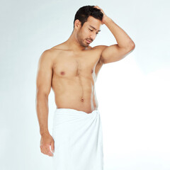 Fototapeta premium Towel, shower and fitness man thinking in studio for wellness, hygiene or body care routine on white background. Cleaning, grooming or muscular Japanese male model with pamper, cosmetics or treatment