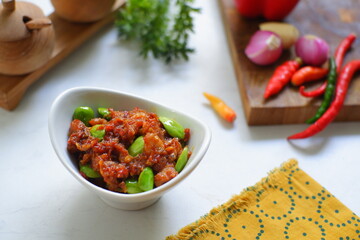 a bowl of sambal with parkia