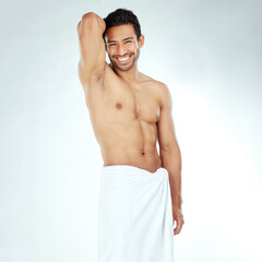 Portrait, body and happy asian man with a towel in studio for shower, wellness or cosmetics on white background. Bathroom, face and Japanese male model smile for luxury pamper, grooming or treatment