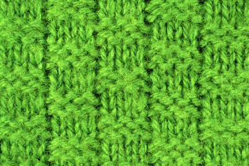 Colored large hand-knitted knitwear lies on the table. Handmade