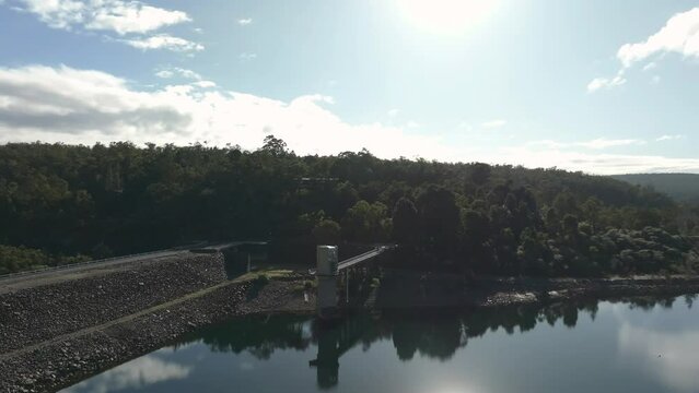 Circling and panning, showing the dry side of Serpentine dam, Karri trees and natural bushland. City of Perth