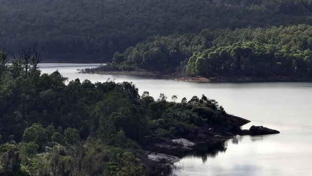 Long focal length of winding river, Australian bushland, hills, trees to the water's edge.