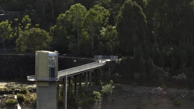 Long focal length, slow pan and sideways movement with watch tower over Serpentine Dam as main focal point.
