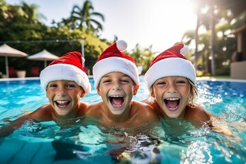 Happy group of kids in santa hat celebrating christmas in swimming pool , winter season and christmas celebration on southern hemisphere or Australia concept image - obrazy, fototapety, plakaty