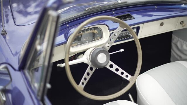 Vintage Blue Car Interior with White Steering Wheel. Close up