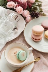 Close-up of a beautiful breakfast on a pink background. Pasta, a cup of coffee, a latte and flowers on the table. Food, mood, comfort concepts.