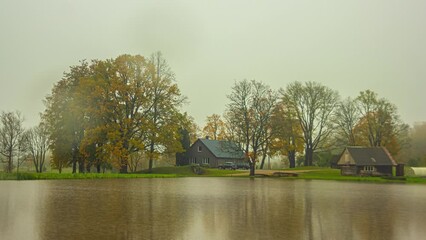 Season weather change transition time lapse summer winter of house near tree and lake 