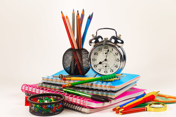 School supplies for primary and secondary school on the table, on a saint background. Back to school.