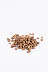 Dry dog food pellets on a white isolated background