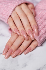 Female hands with pink nail design
