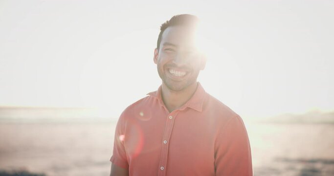 Happy, face and asian man laughing at beach with freedom, joy and positive energy, mindset or attitude outdoor. Adventure, portrait and Japanese male person at the ocean with fresh air at sunset