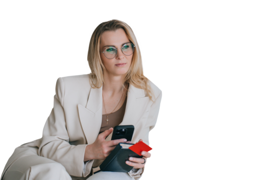 Pensive blonde caucasian businesswoman in beige suit sitting against transparent background looks away holds phone, credit card and diary, pulled by financial crisis, troubles. bills.