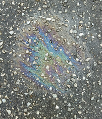 A trace of gasoline on the asphalt as a background. Texture