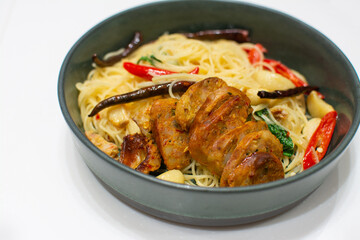 Spaghetti with Northern Thai spicy sausage on white background.